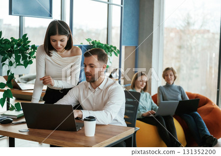 People are working in the office with bean bags chairs in it People are working in the office with bean bags chairs in it 131352200