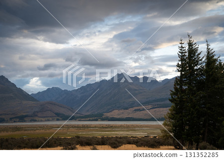 Mountainous landscape with ridgelines and peaks with colorful sunrise cloudscape above, New Zealand Mountainous landscape with ridgelines and peaks with colorful sunrise cloudscape above, New Zealand 131352285