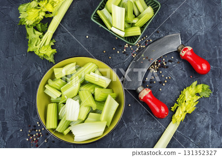 Cut celery sticks and leaves on table. 131352327