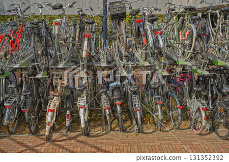 Large multi-level bicycle parking filled with bikes in a busy urban area. 131352392