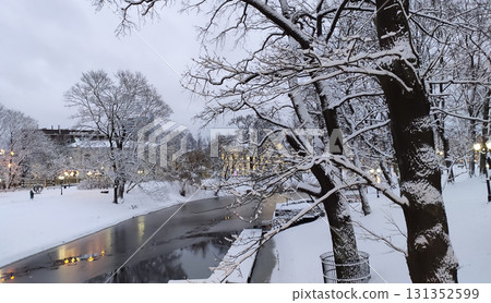 Tranquil snowy park scene in urban environment. Tranquil snowy park scene in urban environment. 131352599