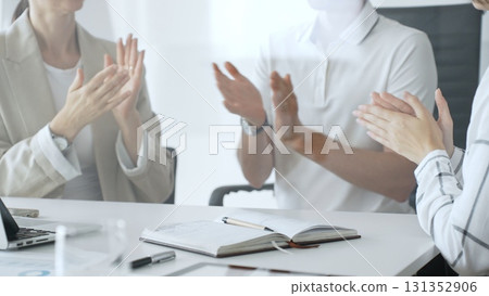 Business team applauding after achieving a goal during a productive meeting in a modern office environment, celebrating success and teamwork, close up Business team applauding after achieving a goal during a productive meeting in a modern office environment, celebrating success and teamwork, close up 131352906