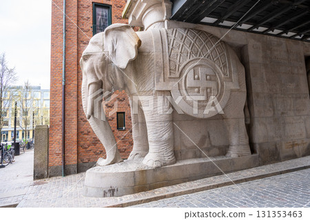 The impressive elephant gate stands at the entrance to the brewery in Copenhagen, Denmark, showcasing intricate stone carvings and unique architecture. It reflects the city's rich brewing heritage. 131353463
