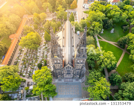 St. Peter and St. Paul Basilica stands majestically in Vysehrad, Prague, bathed in soft morning light. The serene landscape showcases nearby greenery and cemetery, adding to the peaceful atmosphere. St. Peter and St. Paul Basilica stands majestically in Vysehrad, Prague, bathed in soft morning light. The serene landscape showcases nearby greenery and cemetery, adding to the peaceful atmosphere. 131353479