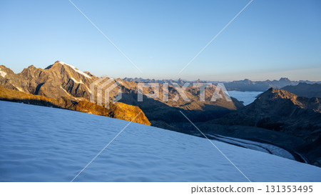 The sun rises over Pers Glacier, illuminating the ice and mountains of the Bernina Range. A serene morning in the Swiss Alps reveals the stunning landscape of Graubunden. The sun rises over Pers Glacier, illuminating the ice and mountains of the Bernina Range. A serene morning in the Swiss Alps reveals the stunning landscape of Graubunden. 131353495