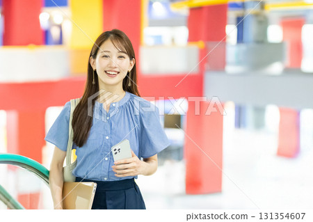 Business woman riding escalator 131354607