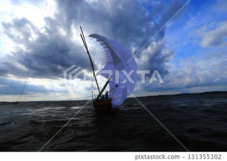 A sailing boat, a seasonal sight on Lake Kasumigaura with Mount Tsukuba in the background 131355102