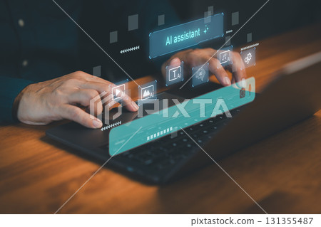 Hands using a laptop computer with AI assistant interface for text, image, video, and music generation, symbolizing artificial intelligence, digital productivity and creative technology solutions. 131355487