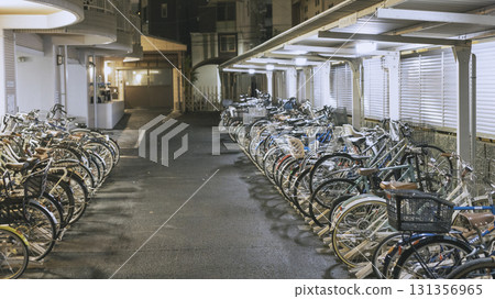Nighttime, apartment complex, bicycle parking lot, bicycles lined up Nighttime, apartment complex, bicycle parking lot, bicycles lined up 131356965