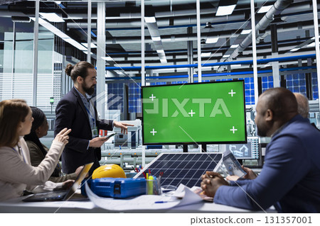 Factory shareholders looking at photovoltaic materials research on isolated screen monitor. Businessmen using chroma key display to show solar panels designs research data analysis Factory shareholders looking at photovoltaic materials research on isolated screen monitor. Businessmen using chroma key display to show solar panels designs research data analysis 131357001