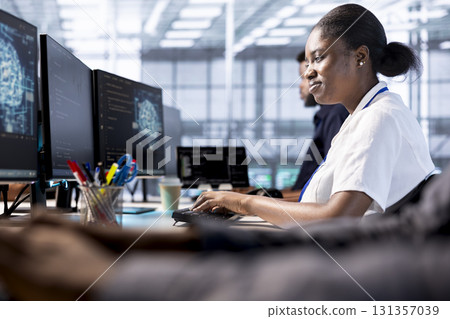 Server farm employee creating AI systems high performance computing engine on PC. Computer scientist in data center developing artificial intelligence capable of producing human cognitive abilities 131357039