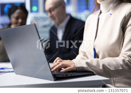 Solar panels plant specialist using laptop to study energy systems, developing new technologies harnessing sun power. Photovoltaics factory researcher works on notebook to improve efficiency, close up 131357071