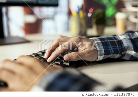 Close up shot of remote worker at home office desk using computer, typing on keyboard, editing documents. Freelancer in apartment using PC to complete spreadsheets, solving tasks Close up shot of remote worker at home office desk using computer, typing on keyboard, editing documents. Freelancer in apartment using PC to complete spreadsheets, solving tasks 131357075