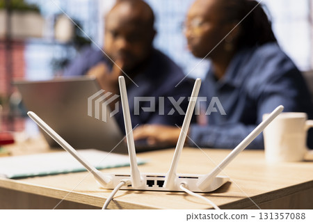 African American man and woman checking with the internet provider for support, discussing possible solutions to their ongoing Wi Fi connectivity issues. Troubleshooting the errors. 131357088