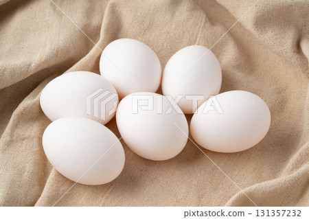 Chicken eggs placed on a cloth 131357232