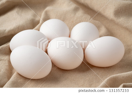 Chicken eggs placed on a cloth 131357233