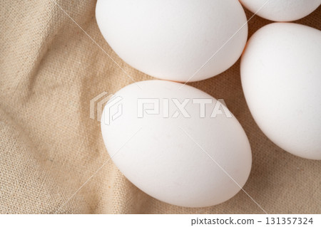 Close-up of chicken eggs placed on a cloth Close-up of chicken eggs placed on a cloth 131357324