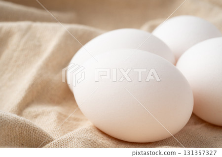 Close-up of chicken eggs placed on a cloth Close-up of chicken eggs placed on a cloth 131357327