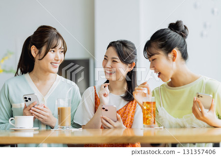 A young woman having a girls-only gathering at a cafe A young woman having a girls-only gathering at a cafe 131357406