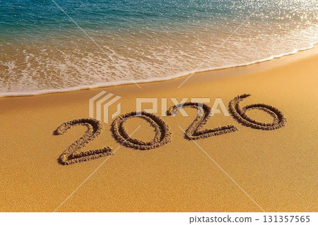 The number 2026 written on the sandy beach as the morning sun shines through 131357565