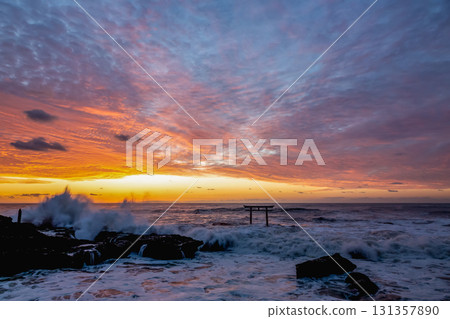 Dawn at the Kamiiso Torii Gate dyed in the morning glow [Oarai Coast, Ibaraki Prefecture] 131357890