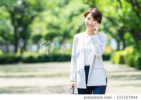 Business woman speaking on a smartphone Business woman speaking on a smartphone 131357944