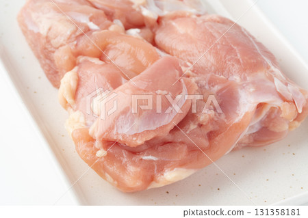 Close-up of raw chicken thighs on a plate Close-up of raw chicken thighs on a plate 131358181