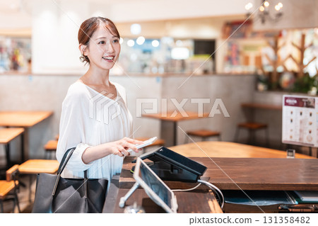 Cashless smartphone payment young woman 131358482