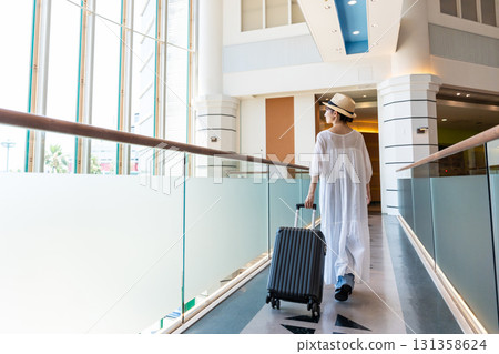 Rear view of a young woman going on a trip 131358624
