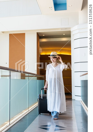 A woman walking down an airport corridor A woman walking down an airport corridor 131358626