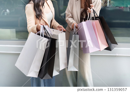 Black Friday shopping excitement with friends and shopping bags Black Friday shopping excitement with friends and shopping bags 131359057