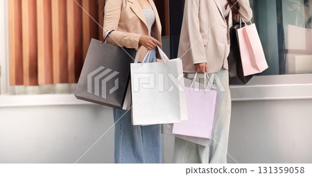 Black Friday Shopping. Two women enjoying a shopping spree with bags in hand. 131359058