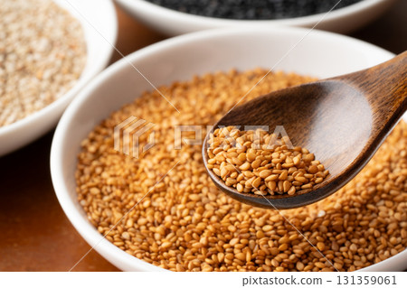 Close-up of golden sesame seeds (raw sesame seeds) on a spoon Close-up of golden sesame seeds (raw sesame seeds) on a spoon 131359061