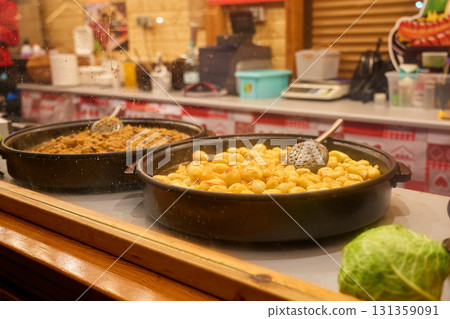 Traditional street food with fried potatoes at Christmas market Traditional street food with fried potatoes at Christmas market 131359091