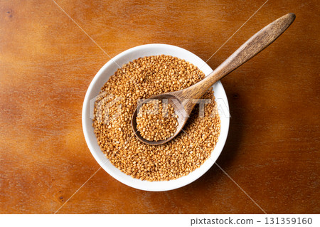 Golden sesame (raw sesame) on a plate and spoon Golden sesame (raw sesame) on a plate and spoon 131359160