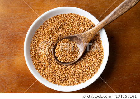 Golden sesame (raw sesame) on a plate and spoon Golden sesame (raw sesame) on a plate and spoon 131359161