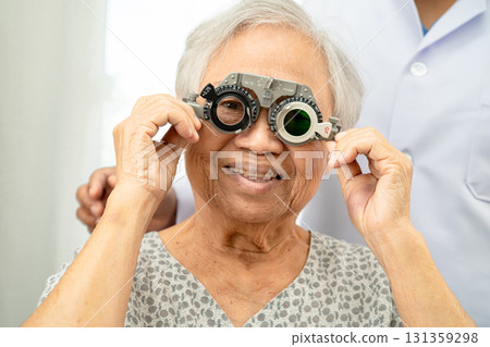 Asian senior woman wearing ophthalmic vision eye test and using optical trial frame. Asian senior woman wearing ophthalmic vision eye test and using optical trial frame. 131359298