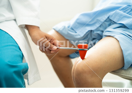Asian doctor physiotherapist examining, massaging and treatment knee and leg of senior patient in orthopedist medical clinic nurse hospital. 131359299