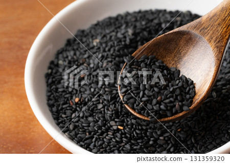Close-up of black sesame seeds (raw sesame seeds) on a spoon 131359320