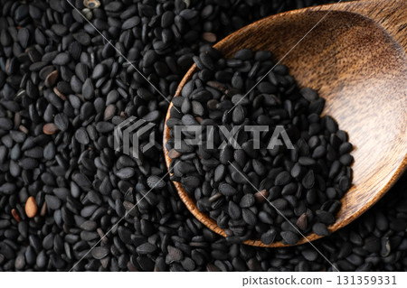 Close-up of black sesame seeds (raw sesame seeds) on a spoon 131359331