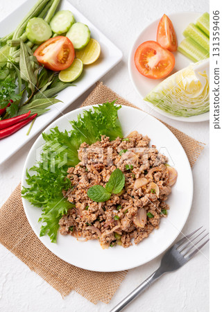 Local Thai food, Spicy minced pork salad (Larb Moo) eating with fresh vegetables on white background Local Thai food, Spicy minced pork salad (Larb Moo) eating with fresh vegetables on white background 131359406
