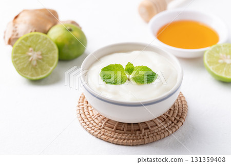 Yogurt, lime, honey and ginger on white background Yogurt, lime, honey and ginger on white background 131359408