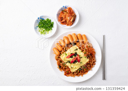 Korean spicy instant noodles with kimchi, sausage and Mozzarella cheese on white background Korean spicy instant noodles with kimchi, sausage and Mozzarella cheese on white background 131359424