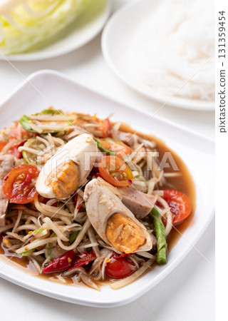 Thai food (Som Tum), Spicy papaya salad with steamed pork sausage and salted egg Thai food (Som Tum), Spicy papaya salad with steamed pork sausage and salted egg 131359454