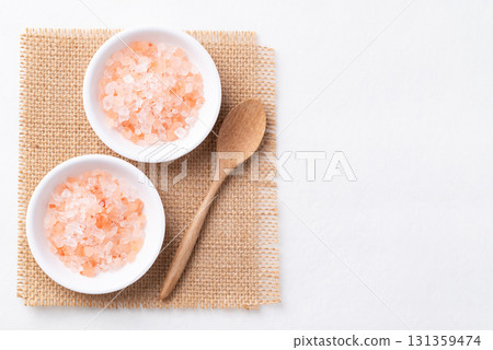 Top view of Himalayan pink salt in bowl with spoon on white background, Healthy food ingredient Top view of Himalayan pink salt in bowl with spoon on white background, Healthy food ingredient 131359474