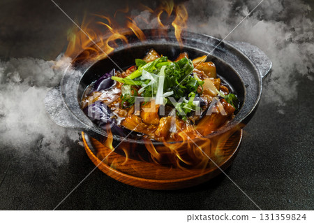 A sizzling medley of steam and flame infused with bold Chinese aromas wok fried stir fries street style claypot dishes and the irresistible fragrance of fish flavored eggplant bubbling in a hot pot 131359824