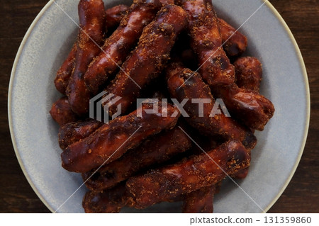 Brown sugar karinto (black karinto) served on a plate on a table background viewed from directly above Brown sugar karinto (black karinto) served on a plate on a table background viewed from directly above 131359860
