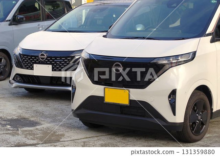 Car image: Nissan cars lined up at a dealership 131359880