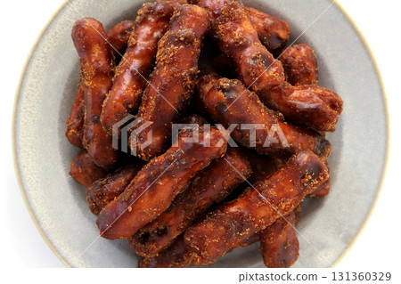 Brown sugar karinto (black karinto) served on a plate on a white background viewed from directly above Brown sugar karinto (black karinto) served on a plate on a white background viewed from directly above 131360329