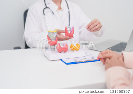 Elderly Patient consulting and Diagnosis with Doctor to Thyroid disease. Anatomy Thyroid model for Hyperthyroidism, Hypothyroidism, Hashimoto Thyroiditis, Thyroid Tumor and Cancer, Papillary Carcinoma Elderly Patient consulting and Diagnosis with Doctor to Thyroid disease. Anatomy Thyroid model for Hyperthyroidism, Hypothyroidism, Hashimoto Thyroiditis, Thyroid Tumor and Cancer, Papillary Carcinoma 131360597